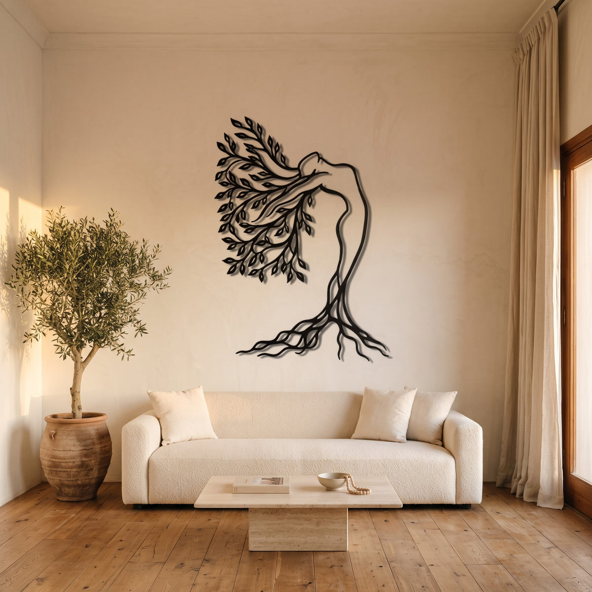 Tree of Life Woman Botanical Metal Wall Art above a sofa in a warm living room