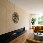 Tree Roots Circular Nature Metal Wall Art, side view on a stone wall above a fireplace